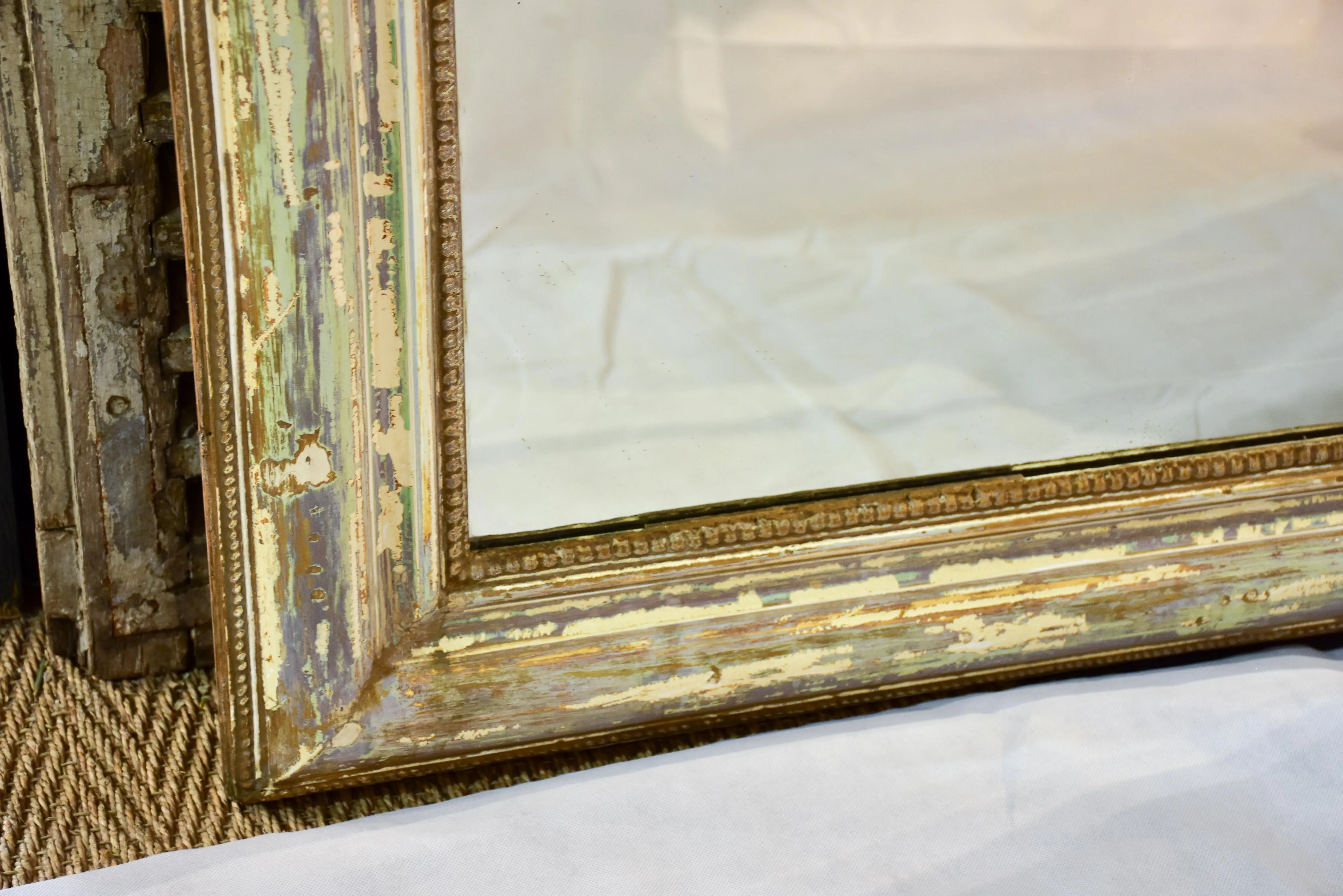 Large 19th century Louis XVI mirror with patinated frame