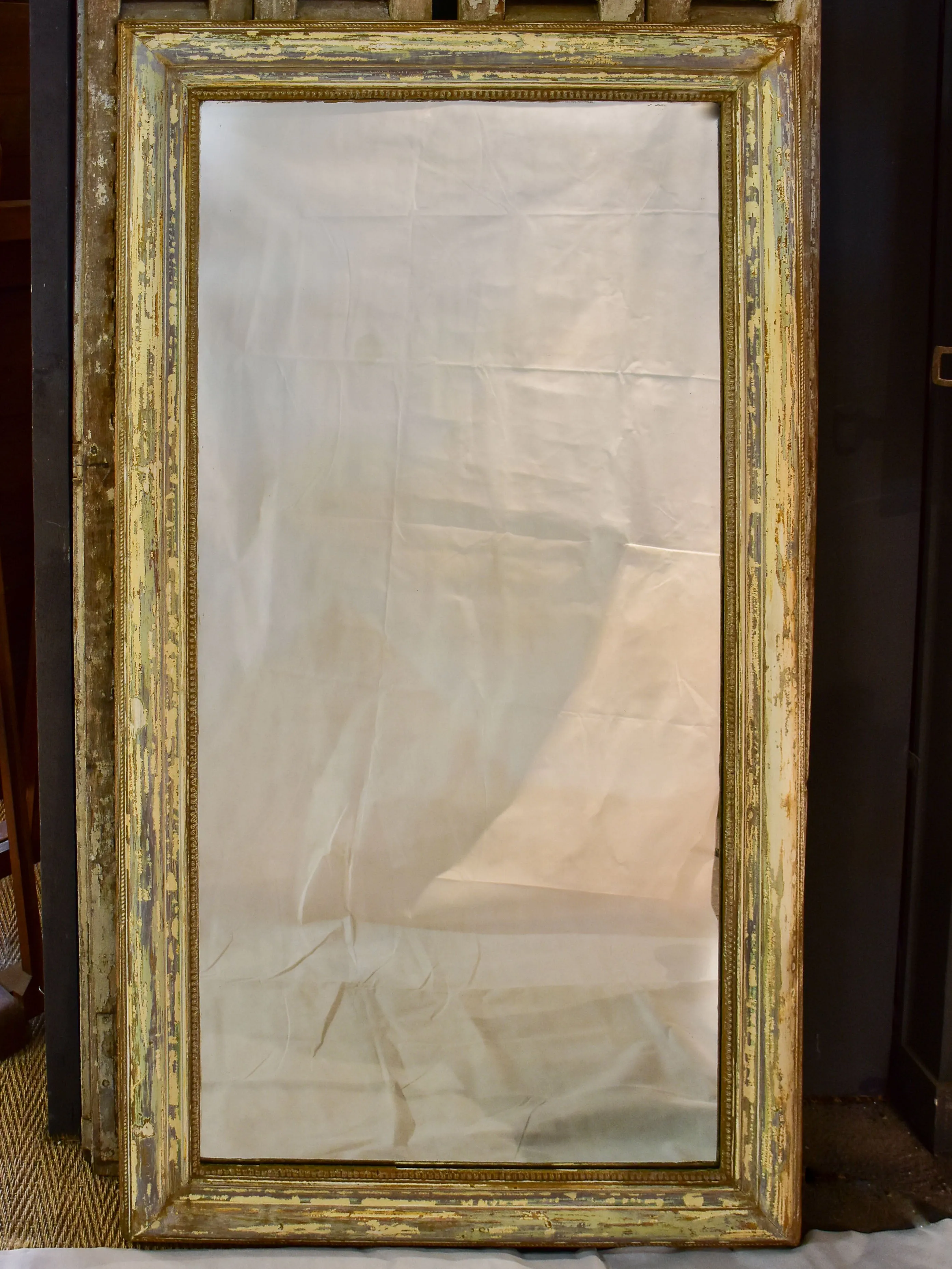 Large 19th century Louis XVI mirror with patinated frame