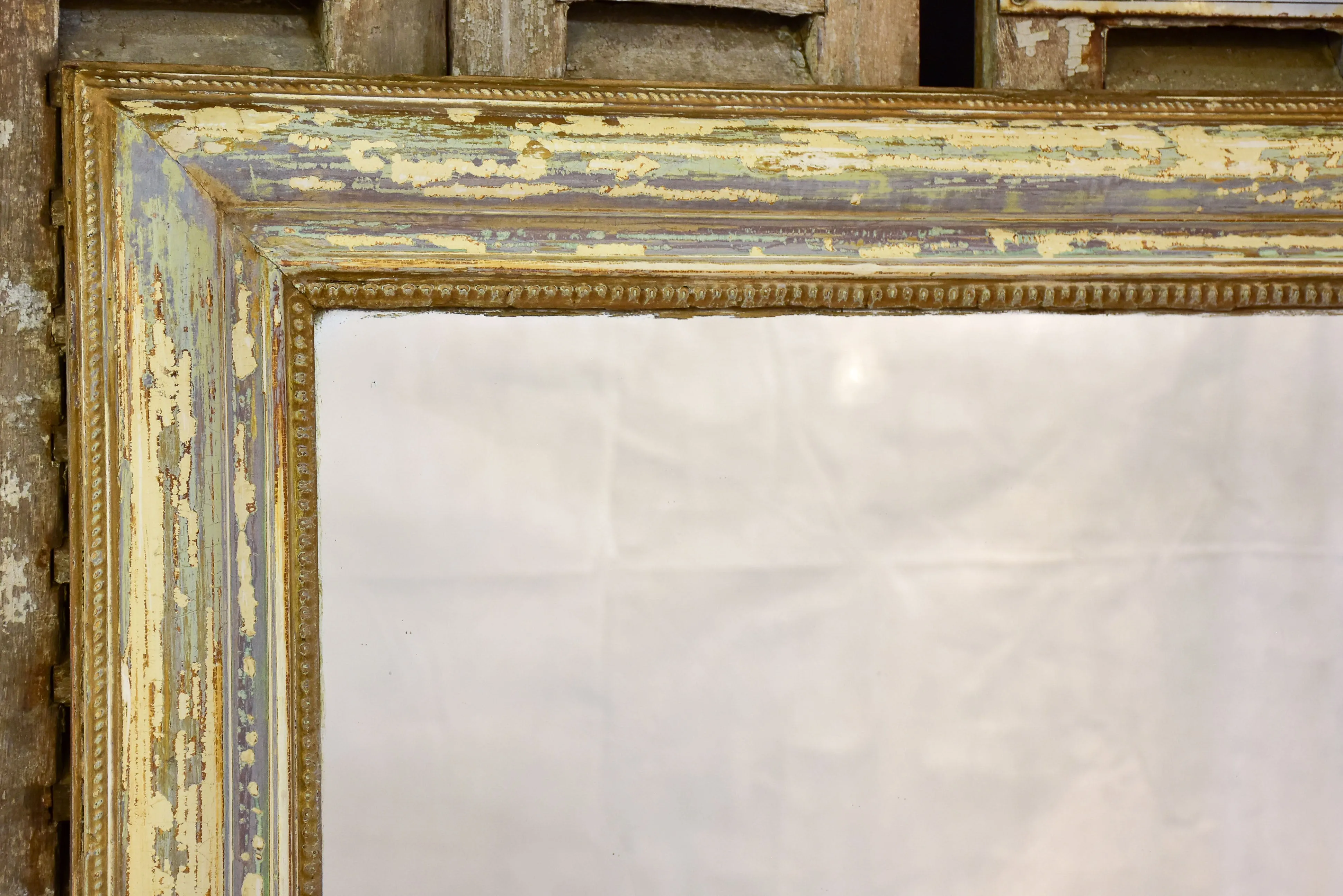 Large 19th century Louis XVI mirror with patinated frame